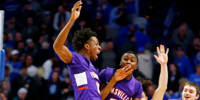 Evansville's DeAndre Williams, top left, and Jawaun Newton (3) celebrate after the team's NCAA college basketball game against Kentucky in Lexington, Ky., Tuesday, Nov. 12, 2019. Evansville won 67-64. (AP Photo/James Crisp)