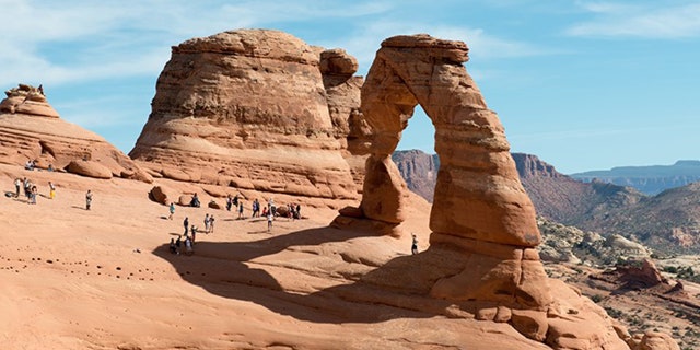 Delicate Arch in Utah sits on the edge of a sandstone bowl with steep slopes that winter ice and snow can leave treacherous.
