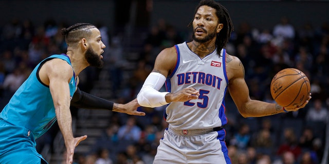 Detroit Pistons guard Derrick Rose, right, looks to pass the ball as Charlotte Hornets forward Cody Martin defends during the second half of an NBA basketball game in Charlotte, N.C., Friday, Nov. 15, 2019. Charlotte won 109-106. (AP Photo/Nell Redmond)