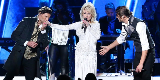 Joel Smallbone and Luke Smallbone of For King & Country and Dolly Parton (M) perform onstage during the 53rd annual CMA Awards at the Music City Center on November 13, 2019 in Nashville, Tennessee. (Photo by Terry Wyatt/Getty Images,)