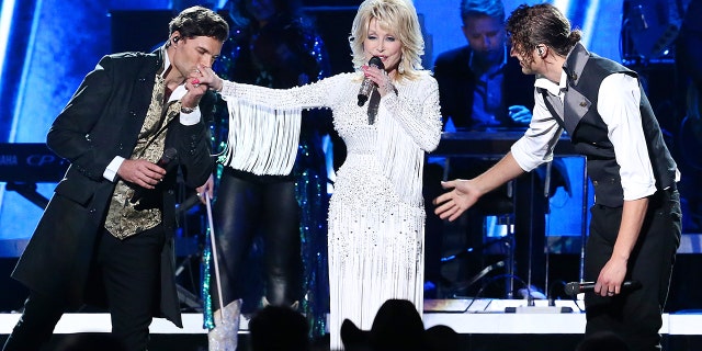 Joel Smallbone and Luke Smallbone of For King & Country and Dolly Parton (M) perform onstage during the 53rd annual CMA Awards at the Music City Center on November 13, 2019 in Nashville, Tennessee. (Photo by Terry Wyatt/Getty Images,)