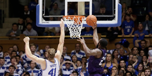 Stephen F. Austin forward Nathan Bain (23) made the game-winning basket over Duke forward Jack White (41) during overtime in an NCAA college basketball game on Tuesday. Stephen F. Austin won 85-83. (AP Photo/Gerry Broome)