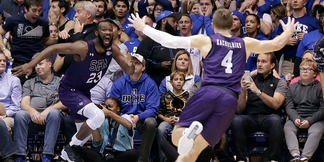 Stephen F. Austin forward Nathan Bain (23) and guard David Kachelries (4) celebrated Bain's game winning basket against Duke in overtime on Tuesday. (AP Photo/Gerry Broome)