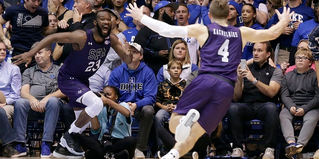 Stephen F. Austin forward Nathan Bain (23) and guard David Kachelries (4) celebrated Bain's game winning basket against Duke in overtime on Tuesday. (AP Photo/Gerry Broome)