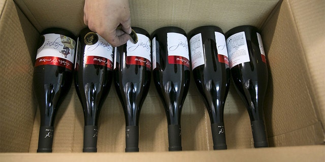 A worker places stickers on wine bottles at Shiloh Wineries, north of the West Bank city of Ramallah.