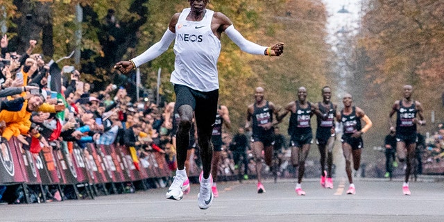 Eliud Kipchoge runs on his way to break the historic two-hour barrier for a marathon in Vienna, Saturday, Oct. 12, 2019. Eliud Kipchoge has become the first athlete to run a marathon in less than two hours while wearing the Nike Vaporfly shoes. (Jed Leicester/The INEOS 1:59 Challenge via AP)