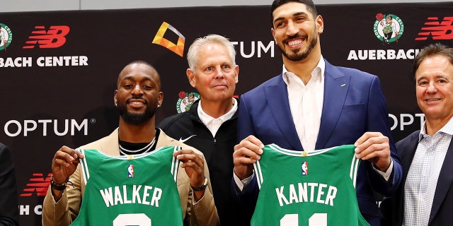 Kemba Walker (L) and Enes Kanter (R) are introduced as members of the Boston Celtics by Celtics President of Basketball Operations Danny Ainge during a press conference at the Auerbach Center at New Balance World Headquarters on July 17, 2019 in Boston, Massachusetts. (Photo by Tim Bradbury/Getty Images)