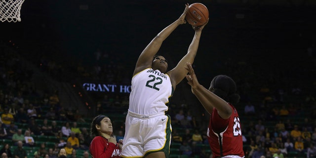 Baylor center Erin DeGrate (22) leaps for the ball against Lamar center Rikiah Cowart (20) and Lamar guard Amber Vidal (5) in the first half of an NCAA college basketball game, Thursday, Nov. 21, 2019, in Waco, Texas. (AP Photo/Jerry Larson)