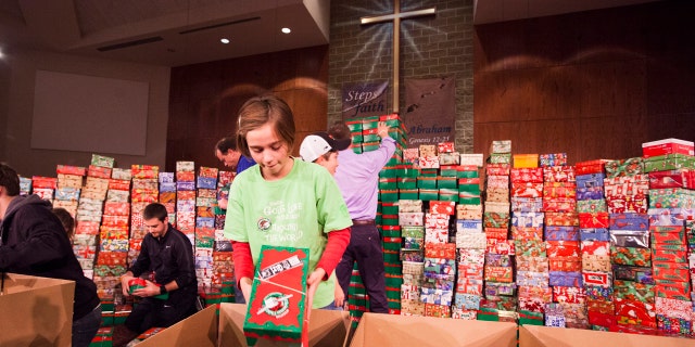 Evilyn Pinnow readies one of hundreds of Operation Christmas Child shoe box gifts to be processed and sent to children in more than 100 countries around the world.