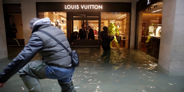 Flood water reaches a luxury shop in Venice, Italy, Sunday, Nov. 17, 2019.