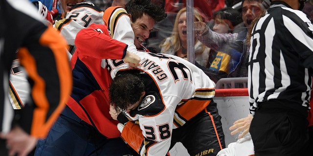 Washington Capitals right wing Garnet Hathaway (21) fights Anaheim Ducks center Derek Grant (38) during the second period of an NHL hockey game, Monday, Nov. 18, 2019, in Washington. (AP Photo/Nick Wass)