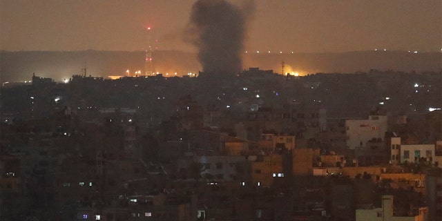 An explosion caused by Israeli airstrikes is seen in Gaza City early Thursday. Israeli aircraft struck Islamic Jihad targets throughout the Gaza Strip on Wednesday while the militant group rained scores of rockets into Israel for a second straight day as the heaviest round of fighting in months showed no signs of ending.