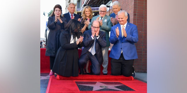 Harry Friedman is honored with a star on The Hollywood Walk of Fame while friends such as Vanna White, Pat Sajak and Alex Trebek watch.