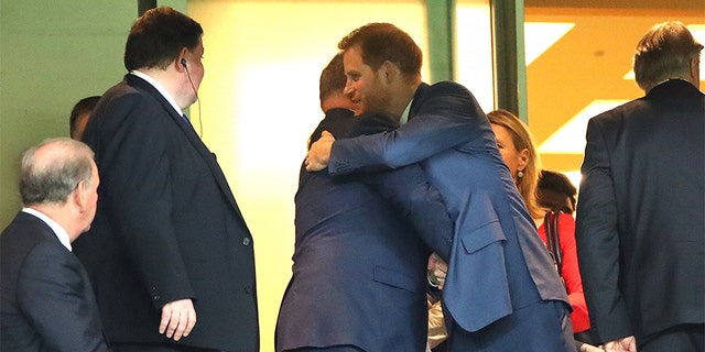 Prince Harry, Duke of Sussex (R) embraces Albert II, Prince of Monaco (L) in the stands during the Rugby World Cup 2019 Final between England and South Africa at International Stadium Yokohama on November 02, 2019 in Yokohama, Kanagawa, Japan.