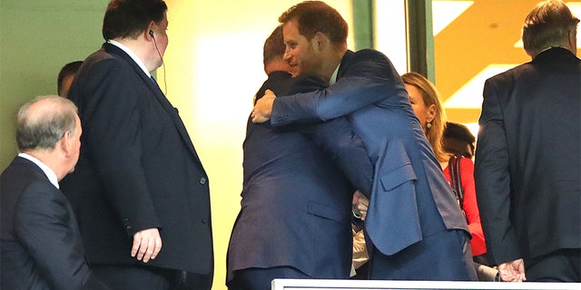 Prince Harry, Duke of Sussex (R) embraces Albert II, Prince of Monaco (L) in the stands during the Rugby World Cup 2019 Final between England and South Africa at International Stadium Yokohama on November 02, 2019 in Yokohama, Kanagawa, Japan.