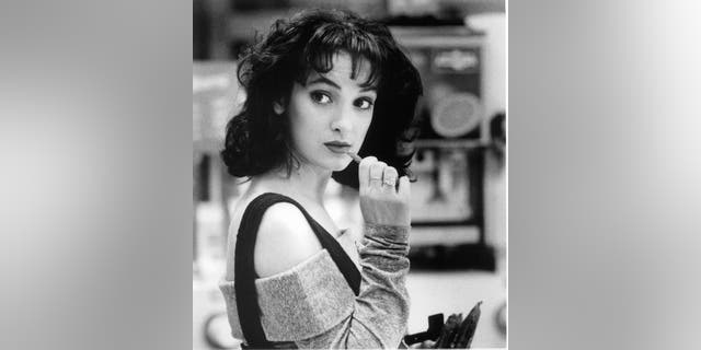 Winona Ryder is about to chew on candy in a scene from the film "Heathers," 1988.
