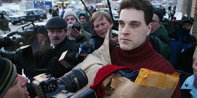 Robert Chambers, wearing a red sweater on a chilly Valentine's Day and clutching a paper bag, brushes past reporters and cameras upon his release from Auburn Correctional Facility this morning. Chambers, the so-called "Preppie Killer," served 15 years for the murder of 18-year-old Jennifer Levin in Central Park on Aug. 26, 1986.