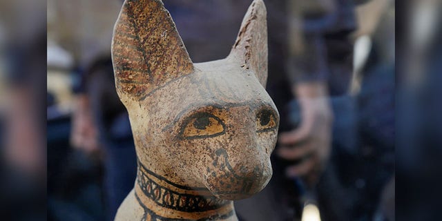 A cat statue that was found inside a cache, at the Saqqara area near its necropolis is pictured in Giza, Egypt, Saturday. (REUTERS/Hayam Adel)