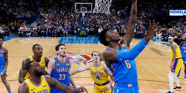 Oklahoma City Thunder guard Hamidou Diallo (6) shoots in front of Los Angeles Lakers forward LeBron James (23) and guard Alex Caruso (4) during the fist half of an NBA basketball game Friday, Nov. 22, 2019, in Oklahoma City. (AP Photo/Sue Ogrocki)