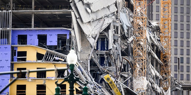 The Hard Rock Hotel partially collapsed onto Canal Street in downtown New Orleans on Oct. 12. (Photo by EMILY KASK/30238387A /AFP via Getty Images)