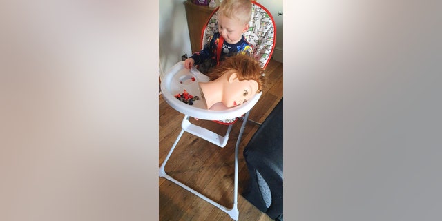 One toddler in the U.K., pictured, has stunned his parents with an obsessive predilection for carrying around a mannequin doll head wherever he goes.