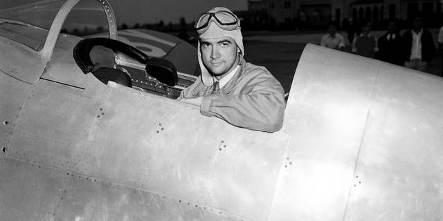 Howard Hughes, industrialist, film producer and pilot, poses in the cockpit of his new racing plane after a test flight in Los Angeles August 17, 1935. The plane, nearly two years in construction at a cost believed to be more than $100,000, was to be piloted by Hughes in the Bendix race from Los Angeles to Cleveland. (AP Photo)