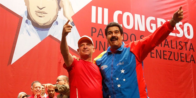 Venezuela's President Nicolas Maduro, right, embracing Hugo Carvajal at a Socialist party congress in Caracas, in July 2014.