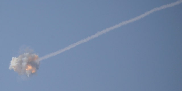 An Israeli Iron Dome air defense system missile is seen intercepting rockets fired from Gaza over Sderot, southern Israel, Wednesday, Nov. 13, 2019. (AP Photo/Ariel Schalit)
