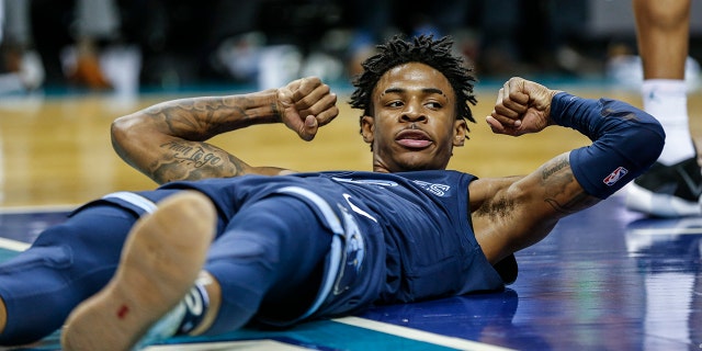 Memphis Grizzlies guard Ja Morant flexes after being fouled in the first half of an NBA basketball game against the Charlotte Hornets in Charlotte, N.C., Wednesday, Nov. 13, 2019. (AP Photo/Nell Redmond)