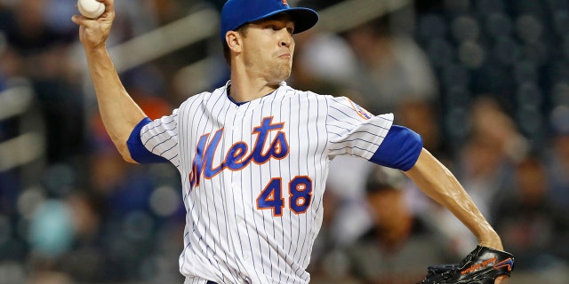 FILE - In this Sept. 9, 2019, file photo, New York Mets starting pitcher Jacob deGrom winds up during the first inning of the team's baseball game against the Arizona Diamondbacks in New York. Mets' deGrom has been named the NL Cy Young Award winner for the second straight year. (AP Photo/Kathy Willens, File)