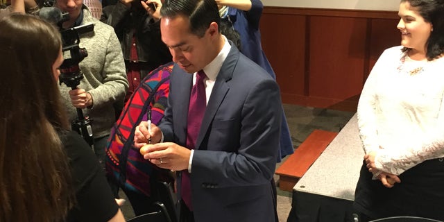 Democratic presidential candidate Julian Castro signs the famed wooden eggs as he headlines 'Politics and Eggs' at the New Hampshire Institute of Politics in Manchester, NH in January, 2019