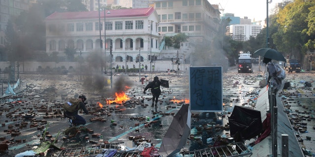 Protesters react during a confrontation at the Hong Kong Polytechnic University in Hong Kong, Sunday, Nov. 17, 2019.