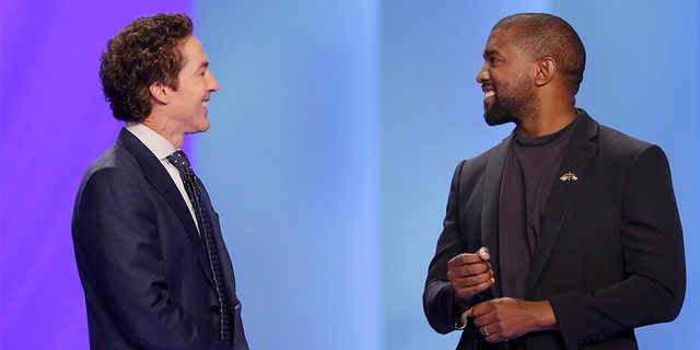 Kanye West, right, answering questions from Joel Osteen earlier Sunday in Houston. (Associated Press)