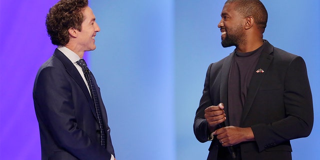 Kanye West, right, answering questions from Joel Osteen earlier Sunday in Houston. (Associated Press)