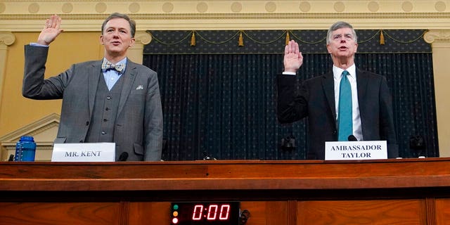 Career Foreign Service officer George Kent and top U.S. diplomat in Ukraine William Taylor, right, are sworn in to testify during the first public impeachment hearing of the House Intelligence Committee on Capitol Hill, Wednesday Nov. 13, 2019, in Washington. (Joshua Roberts/Pool via AP)