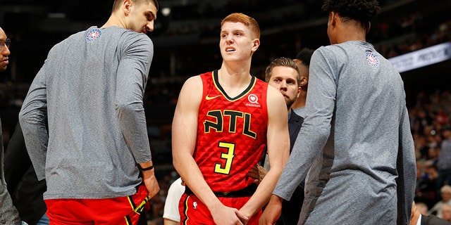 Atlanta Hawks guard Kevin Huerter holds his left wrist after an injury during the second half of the team's NBA basketball game agains the Denver Nuggets on Tuesday, Nov. 12, 2019, in Denver. Atlanta won 125-121. (AP Photo/David Zalubowski)