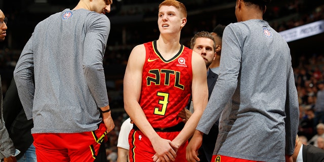 Atlanta Hawks guard Kevin Huerter holds his left wrist after an injury during the second half of the team's NBA basketball game agains the Denver Nuggets on Tuesday, Nov. 12, 2019, in Denver. Atlanta won 125-121. (AP Photo/David Zalubowski)