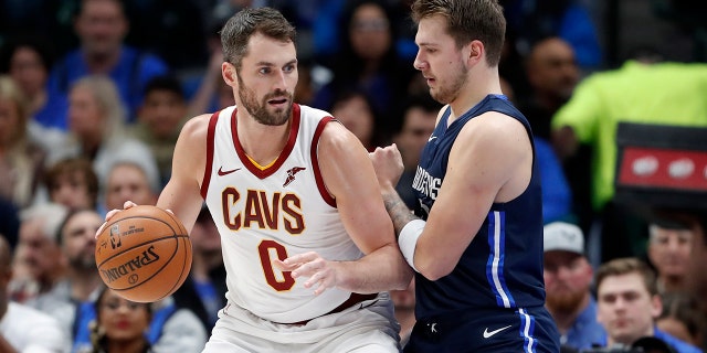 Cleveland Cavaliers forward Kevin Love (0) works against Dallas Mavericks forward Luka Doncic (77) for a shot opportunity in the first half of an NBA basketball game in Dallas, Friday, Nov. 22, 2019. (AP Photo/Tony Gutierrez)