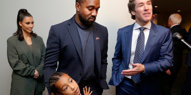 From left, Kim Kardashian West, North West, Kanye West and Joel Osteen answering questions after the 11 a.m. service at Lakewood Church in Houston this past November. (AP Photo/Michael Wyke)