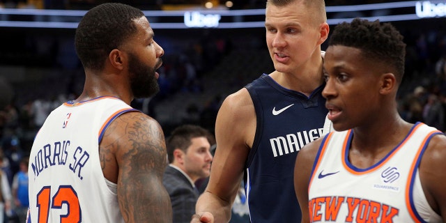 New York Knicks forward Marcus Morris (13) shakes hands with Dallas Mavericks forward Kristaps Porzingis (6) after NBA basketball game Friday, Nov. 8, 2019, in Dallas. (AP Photo/Richard W. Rodriguez)