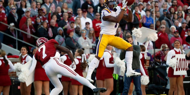 Ja'Marr Chase catches a touchdown pass from Joe Burrow for the first score of Saturday's game. (AP Photo/John Bazemore)