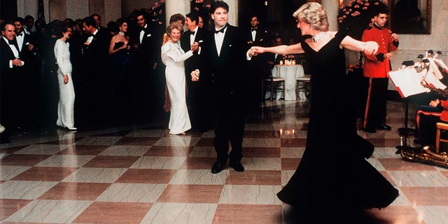Princess Diana dances with actor John Travolta in a dress designed by Victor Edelstein, whilst attending a State Dinner at the White House in 1985.