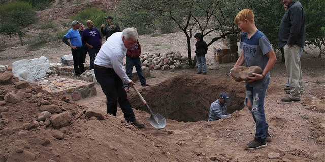 Men dug a mass grave for some of the victims who were killed in Monday's Mexican cartel ambush. (AP Photo/Marco Ugarte)