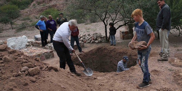 Men dug a mass grave for some of the victims who were killed in Monday's Mexican cartel ambush. (AP Photo/Marco Ugarte)