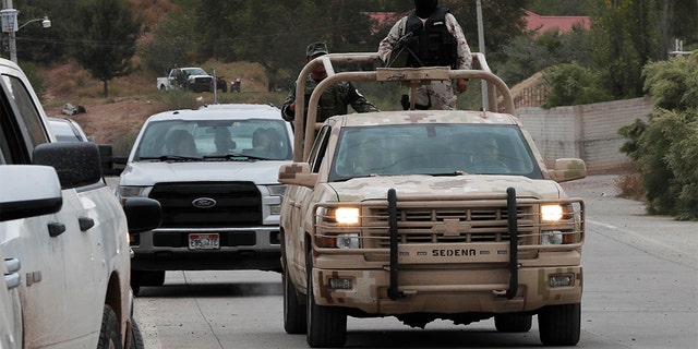 Soldiers patrol La Mora ahead of the funeral Thursday. (AP Photo/Marco Ugarte)