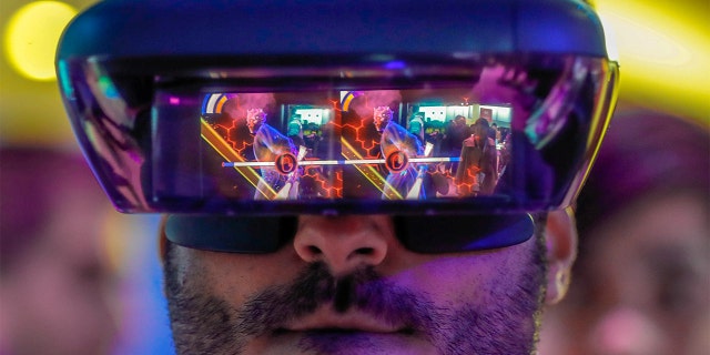 A visitor tries Lenovo's augmented reality glasses with the Star Wars-Jedi-challenges during the Mobile World Congress in Barcelona, Spain, February 26, 2018. REUTERS/Yves Herman TPX IMAGES OF the DAY - RC1EAA1E2450