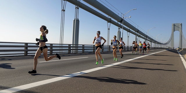 Competitors in the elite women's runners division make their way across the Verrazano-Narrows Bridge during the start of the New York City Marathon, Sunday, Nov. 3, 2019, in New York.