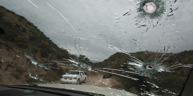 Bullet-riddled vehicles that members of the extended LeBaron family were traveling in sit parked on a dirt road near Bavispe, at the Sonora-Chihuahua state border, Mexico, Wednesday, Nov. 6, 2019. (Associated Press)