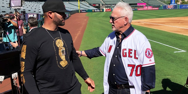 Los Angeles Angels first baseman Albert Pujols speaks with new manager Joe Maddon after a baseball news conference at Angel Stadium in Anaheim, Calif., Thursday, Oct. 24, 2019. Maddon is returning to the Angels, where he worked as a coach before successful managerial stunts with baseball clubs in Tampa Bay and Chicago. (AP Photo/Greg Beacham)