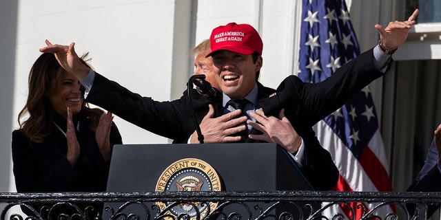 First lady Melania Trump laughs as President Trump hugs Washington Nationals catcher Kurt Suzuki during an event to honor the 2019 World Series Champion, Washington Nationals, at the White House, Monday, Nov. 4, 2019, in Washington. (AP Photo/ Evan Vucci)